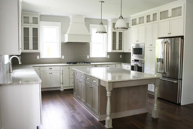 Example of a transitional u-shaped medium tone wood floor open concept kitchen design in Richmond with a farmhouse sink, shaker cabinets, white cabinets, granite countertops, gray backsplash, stainless steel appliances and an island