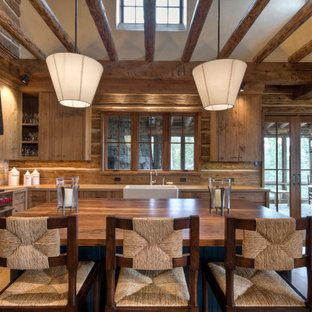 Mid-sized traditional eat-in kitchen inspiration - Eat-in kitchen - mid-sized traditional l-shaped light wood floor eat-in kitchen idea in Other with a farmhouse sink, medium tone wood cabinets, stainless steel appliances, porcelain backsplash, flat-panel cabinets, solid surface countertops, brown backsplash and an island