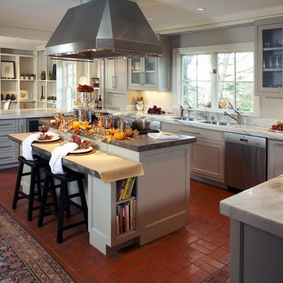 Kitchen - traditional kitchen idea in Dallas with glass-front cabinets and marble countertops