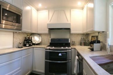 Small transitional galley slate floor enclosed kitchen photo in Other with an undermount sink, flat-panel cabinets, white cabinets, granite countertops, white backsplash, stone slab backsplash, stainless steel appliances and no island