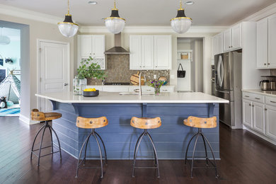 Mid-sized transitional l-shaped dark wood floor eat-in kitchen photo in Raleigh with an undermount sink, raised-panel cabinets, gray cabinets, quartz countertops, gray backsplash, glass tile backsplash, stainless steel appliances and an island