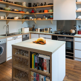 Inspiration for a medium sized retro l-shaped open plan kitchen in Other with light wood cabinets, wood worktops, stainless steel appliances, an island, medium hardwood flooring, brown floors and white worktops.