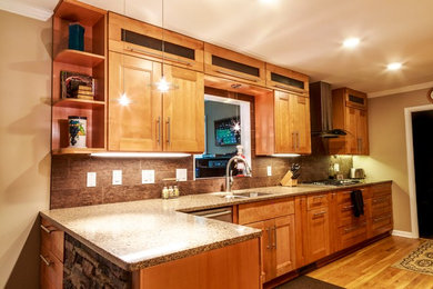 Example of a small trendy galley light wood floor and beige floor eat-in kitchen design in Atlanta with an undermount sink, shaker cabinets, light wood cabinets, solid surface countertops, black backsplash, ceramic backsplash, stainless steel appliances and no island
