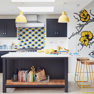 Design ideas for a medium sized contemporary l-shaped open plan kitchen in Other with shaker cabinets, blue cabinets, an island, multi-coloured splashback and beige floors.