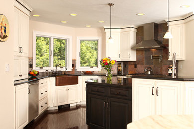 Eat-in kitchen - transitional u-shaped eat-in kitchen idea in New York with a farmhouse sink, raised-panel cabinets, white cabinets, granite countertops and stainless steel appliances