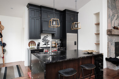 Example of a small transitional kitchen design in Toronto with a drop-in sink, black cabinets, granite countertops, stainless steel appliances and an island