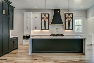 Transitional eat-in kitchen photo in Nashville with shaker cabinets, white cabinets and an island