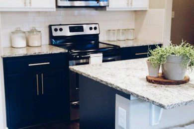 Inspiration for a modern kitchen remodel in Portland with black cabinets and white backsplash