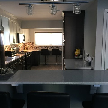 Black and White Kitchen with Stainless Steel Backsplash
