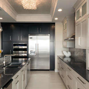 Mid-sized minimalist l-shaped ceramic tile eat-in kitchen photo in Miami with an undermount sink, flat-panel cabinets, white cabinets, quartz countertops, multicolored backsplash, mosaic tile backsplash, stainless steel appliances and an island