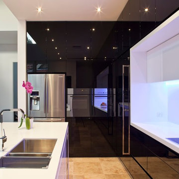 black gloss kitchen with white stone