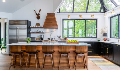 Cream kitchen cabinets in a loghome.