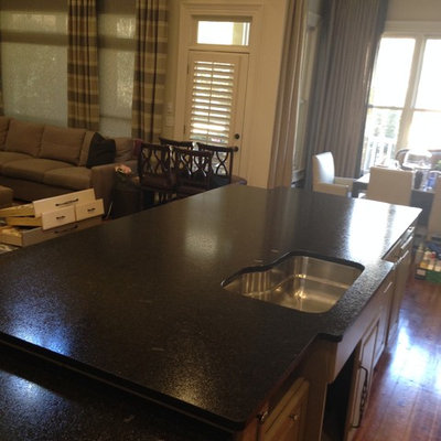 Large transitional u-shaped medium tone wood floor eat-in kitchen photo in Atlanta with a single-bowl sink, raised-panel cabinets, beige cabinets, granite countertops, multicolored backsplash and stainless steel appliances