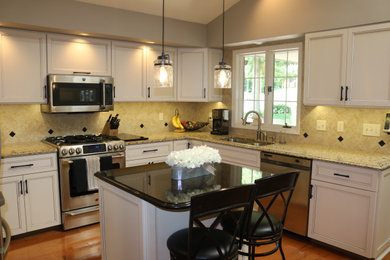 This is an example of a medium sized traditional u-shaped enclosed kitchen in Grand Rapids with a double-bowl sink, recessed-panel cabinets, white cabinets, granite worktops, brown splashback, ceramic splashback, stainless steel appliances, medium hardwood flooring, an island, brown floors and brown worktops.