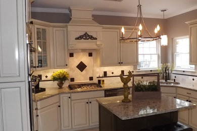 Inspiration for a large timeless u-shaped eat-in kitchen remodel in Atlanta with an undermount sink, raised-panel cabinets, white cabinets, granite countertops, beige backsplash, ceramic backsplash, stainless steel appliances and an island