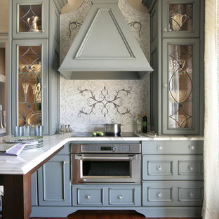 Small victorian u-shaped eat-in kitchen in New York with a drop-in sink, stainless steel appliances, medium hardwood floors, with island, recessed-panel cabinets, blue cabinets, marble benchtops, white splashback and marble splashback.