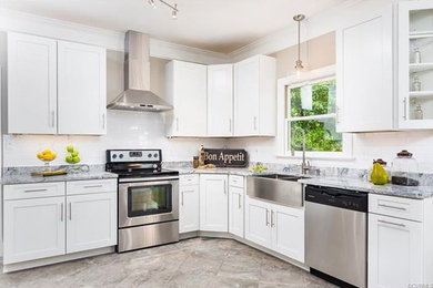 Mid-sized minimalist l-shaped gray floor kitchen photo in Richmond with a farmhouse sink, white cabinets, granite countertops, white backsplash and stainless steel appliances