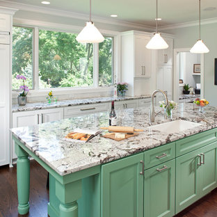Design ideas for an expansive traditional galley eat-in kitchen in Minneapolis with an undermount sink, recessed-panel cabinets, green cabinets, panelled appliances, dark hardwood floors, granite benchtops, multi-coloured splashback, subway tile splashback and with island.