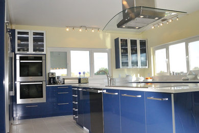 Eat-in kitchen - large modern eat-in kitchen idea in Other with flat-panel cabinets, blue cabinets and an island