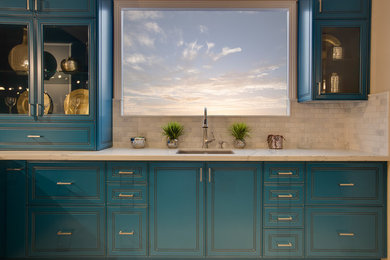 Inspiration for a small coastal galley eat-in kitchen remodel in Orange County with a farmhouse sink, glass-front cabinets, blue cabinets, quartz countertops, gray backsplash and ceramic backsplash