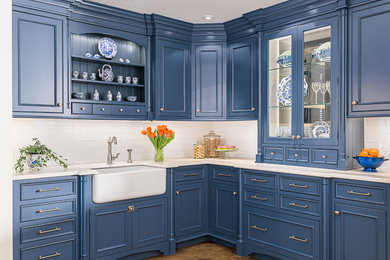 Example of a small classic l-shaped medium tone wood floor enclosed kitchen design in New York with a farmhouse sink, beaded inset cabinets, blue cabinets, soapstone countertops, white backsplash, subway tile backsplash, paneled appliances and no island