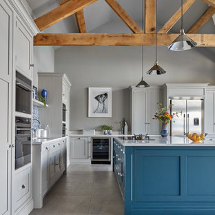 Inspiration for an expansive transitional l-shaped open plan kitchen in Other with an integrated sink, shaker cabinets, grey cabinets, quartzite benchtops, blue splashback, stone tile splashback, stainless steel appliances, porcelain floors, with island, grey floor and white benchtop.