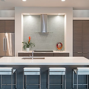 Photo of a large modern eat-in kitchen in Atlanta with an undermount sink, flat-panel cabinets, brown cabinets, grey splashback, glass tile splashback, stainless steel appliances, medium hardwood floors, with island and quartz benchtops.