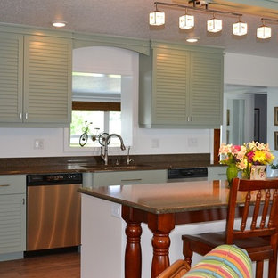 Design ideas for a mid-sized beach style l-shaped eat-in kitchen in Orlando with a double-bowl sink, louvered cabinets, green cabinets, stainless steel appliances and with island.