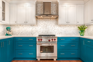 シアトルにあるお手頃価格の小さなトランジショナルスタイルのおしゃれなキッチン (アンダーカウンターシンク、シェーカースタイル扉のキャビネット、青いキャビネット、クオーツストーンカウンター、白いキッチンパネル、大理石のキッチンパネル、シルバーの調理設備、淡色無垢フローリング、白いキッチンカウンター) の写真