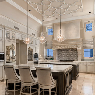 Inspiration for an expansive mediterranean u-shaped open plan kitchen in Phoenix with a farmhouse sink, recessed-panel cabinets, light wood cabinets, quartzite benchtops, multi-coloured splashback, porcelain splashback, stainless steel appliances, marble floors, multiple islands, multi-coloured floor and multi-coloured benchtop.