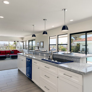 Design ideas for a large transitional single-wall eat-in kitchen in San Diego with an undermount sink, raised-panel cabinets, white cabinets, granite benchtops, multi-coloured splashback, ceramic splashback, coloured appliances, porcelain floors, with island, beige floor and blue benchtop.