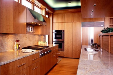 Large minimalist l-shaped light wood floor kitchen pantry photo in Other with a drop-in sink, flat-panel cabinets, medium tone wood cabinets, granite countertops, beige backsplash, stainless steel appliances and an island