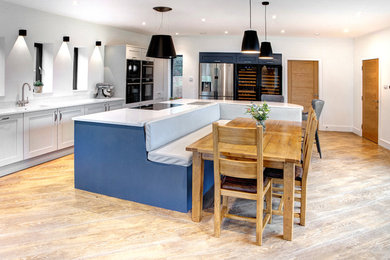 Photo of an expansive contemporary single-wall kitchen/diner in Other with an integrated sink, shaker cabinets, quartz worktops, an island and white worktops.