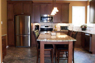 Example of a mid-sized transitional l-shaped open concept kitchen design in Philadelphia with shaker cabinets, dark wood cabinets, granite countertops, beige backsplash, ceramic backsplash, stainless steel appliances and an island