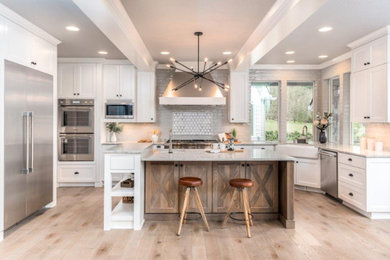 Example of a transitional kitchen design in Portland with shaker cabinets and white cabinets
