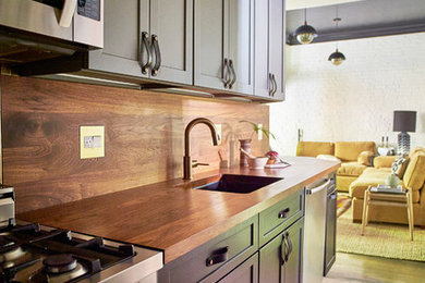 ボストンにあるエクレクティックスタイルのおしゃれなI型キッチン (アンダーカウンターシンク、木材カウンター、シルバーの調理設備、無垢フローリング) の写真