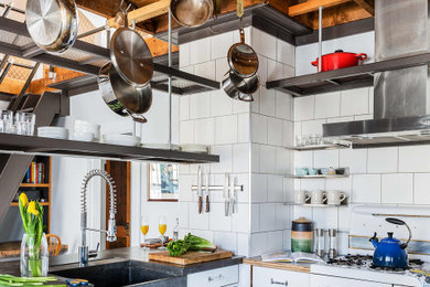 Inspiration for a mid-sized contemporary l-shaped exposed beam eat-in kitchen remodel in Boston with an undermount sink, open cabinets, white cabinets, concrete countertops, white backsplash, cement tile backsplash, white appliances, a peninsula and gray countertops