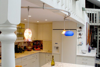 Example of a mid-sized trendy l-shaped ceramic tile eat-in kitchen design in Boston with an undermount sink, flat-panel cabinets, white cabinets, quartz countertops, multicolored backsplash, white appliances and an island