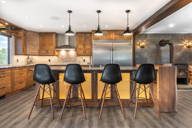 Mid-sized mountain style l-shaped eat-in kitchen photo in Vancouver with an undermount sink, granite countertops, gray backsplash, stainless steel appliances, an island and multicolored countertops