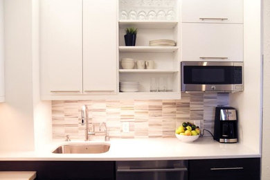 Small trendy l-shaped eat-in kitchen photo in Denver with flat-panel cabinets, a single-bowl sink, quartz countertops, multicolored backsplash, mosaic tile backsplash and stainless steel appliances