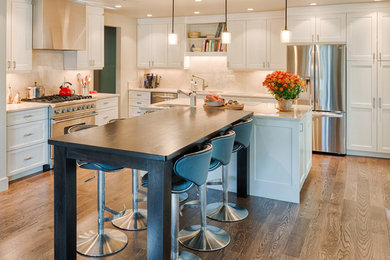 Inspiration for a mid-sized contemporary l-shaped plywood floor open concept kitchen remodel in Denver with a drop-in sink, shaker cabinets, white cabinets, granite countertops, white backsplash, stainless steel appliances and two islands
