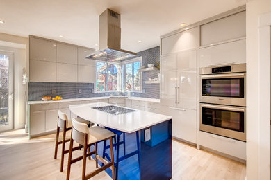 Design ideas for a contemporary l-shaped kitchen in Denver with a double-bowl sink, flat-panel cabinets, blue splashback, mosaic tiled splashback, integrated appliances, light hardwood flooring, an island, white worktops, grey cabinets and beige floors.