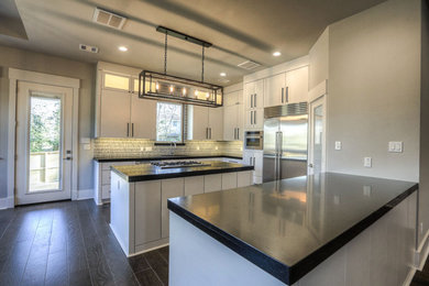 Enclosed kitchen - mid-sized contemporary l-shaped dark wood floor and black floor enclosed kitchen idea in Houston with flat-panel cabinets, white cabinets, quartz countertops, an island, an undermount sink and stainless steel appliances