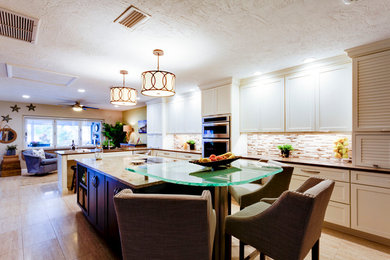 Eat-in kitchen - large transitional l-shaped porcelain tile and beige floor eat-in kitchen idea in Tampa with an undermount sink, shaker cabinets, white cabinets, granite countertops, beige backsplash, matchstick tile backsplash, stainless steel appliances and an island