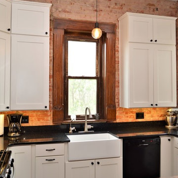 Bourbon, IN. Haas Signature Collection. Farmhouse Kitchen with Exposed Brick