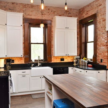 Bourbon, IN. Haas Signature Collection. Farmhouse Kitchen with Exposed Brick