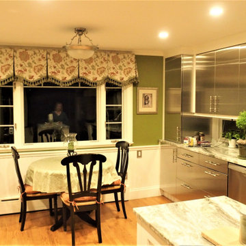 Box pleat valances with a shaped hem and tassel trim in a green kitchen