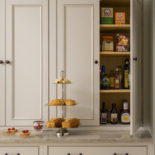 Large traditional l-shaped eat-in kitchen in Boston with an undermount sink, recessed-panel cabinets, white cabinets, granite benchtops, grey splashback, glass tile splashback, stainless steel appliances, light hardwood floors, with island and brown floor.