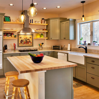 Kitchen - mid-sized craftsman l-shaped medium tone wood floor and brown floor kitchen idea in Other with a farmhouse sink, shaker cabinets, green cabinets, an island, white appliances and beige countertops