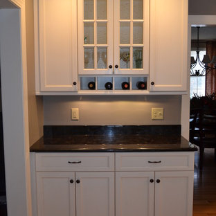 Large traditional eat-in kitchen remodeling - Example of a large classic u-shaped light wood floor eat-in kitchen design in Boston with a single-bowl sink, recessed-panel cabinets, white cabinets, granite countertops, white backsplash, subway tile backsplash, stainless steel appliances and an island